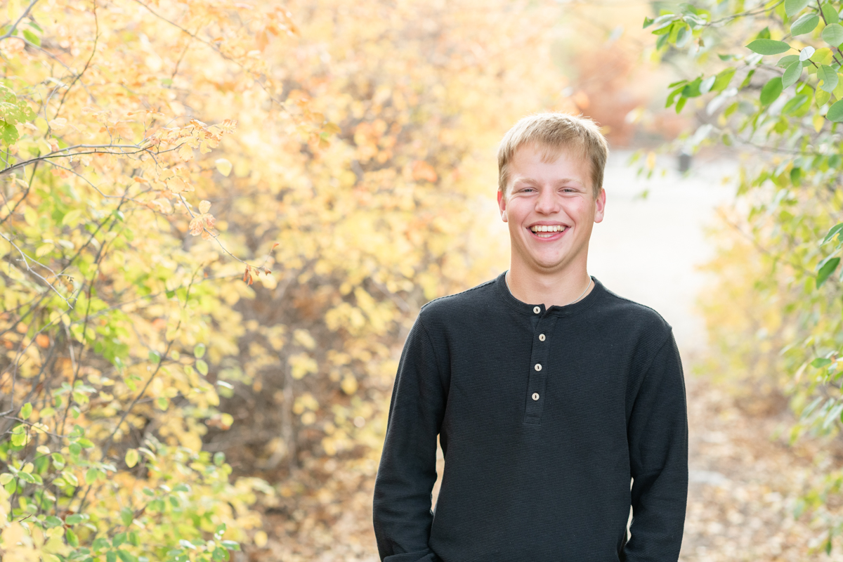 Senior boy smiling in the fall